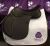 A brown leather Cavaletti Collection jump saddle Ex DEMO 17.5 Brown displayed on a white quilted saddle pad with the brand logo.